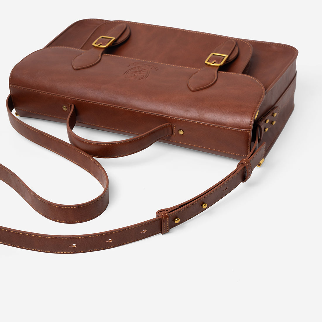Messenger satchel lying flat with its long strap